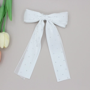 Elegant white double-layered bow hair clip with long ribbons and sparkling rhinestones
