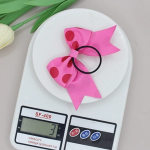 Detailweergave van een roze polkadot grosgrain strik gewogen op een digitale weegschaal