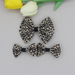 Detailed view of leopard print bow hair clips set with ribbed texture and chic style