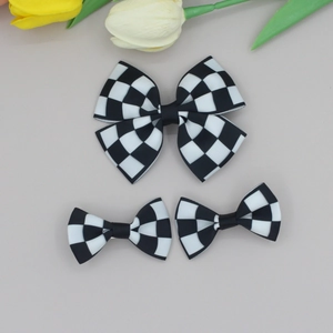 Three-piece black and white checkered ribbon bow hair clip set with grosgrain texture