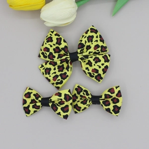Detailed view of leopard print bow hair clips set on elegant background with tulips