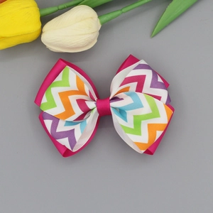 Handmade double-layered pink ribbon hair bow with colorful zigzag patterns for girls