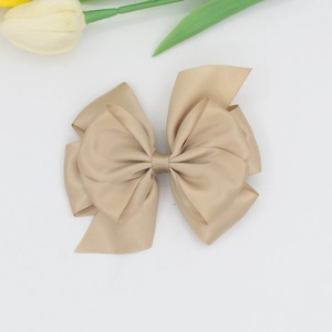 Detail of multi-layer champagne ribbon hair clip with high-quality ribbed texture