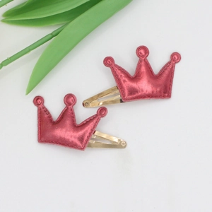 Detail of rose red leather crown hair clips with gold metal duckbill fasteners