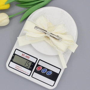 Elegant cream lace bow hair clip with plum blossom accents and ribbon streamers