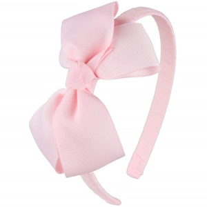 Detail of light pink ribbed fabric texture on child's large bow headband accessory
