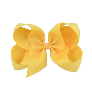 Detailed view of yellow ribbed grosgrain 6-inch swallowtail hair bow for girls