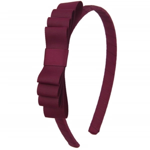 Detail of burgundy grosgrain ribbon headband featuring a layered 3D bow design