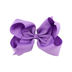 Detailed texture of a 6-inch purple grosgrain ribbon swallowtail hair bow for girls