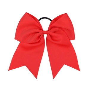 Close-up of 8-inch red grosgrain ribbon bow showing high-density ribbed texture and elastic band