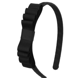 Close-up of black multi-layer grosgrain ribbon bow headband with detailed texture