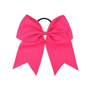 Macro detail of the ribbed grosgrain texture and hot pink swallowtail ribbon bow