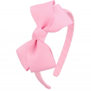 Close-up of pink ribbed grosgrain ribbon bow headband showing high-quality fabric texture