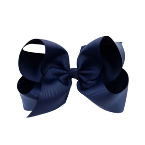 Macro detail of the high-density navy blue grosgrain ribbon texture on 6-inch hair bow