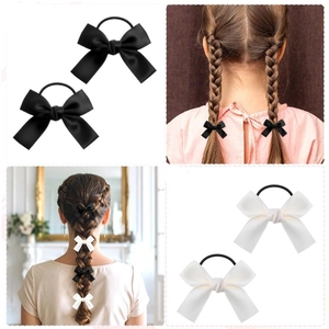 Elegant bow hair ties set in black and white satin finish for stylish ponytails