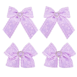 Detailed view of light purple lace hair clips with heart-shaped rhinestones and ribbons