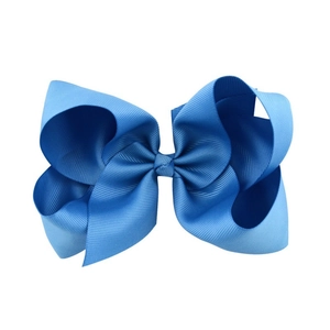 Detailed view of the 6-inch navy blue grosgrain ribbon bow clip with ribbed texture