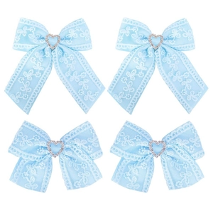 Detail of four light blue lace hair bows with heart rhinestone center and long ribbons