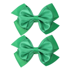 Detail view of two green grosgrain ribbon hair bows with double-layered handmade design