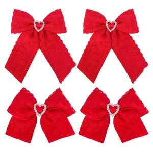 Detail of red lace bow hair clips with heart rhinestones and long ribbons for girls