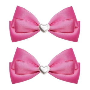Detail view of two rose pink satin bow hair clips with heart-shaped pearl center