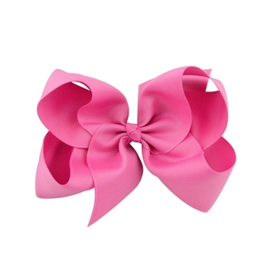 Detail of 6 inch layered grosgrain ribbon bow in bright rose pink with ribbed texture