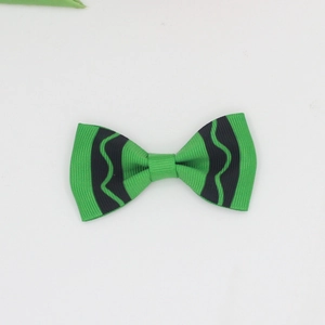 Green grosgrain ribbon hair bow with black wavy trim and symmetrical princess style design