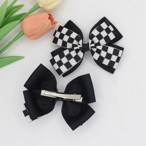 Set of two black and white checkered bow hair clips with silver metal crocodile clips