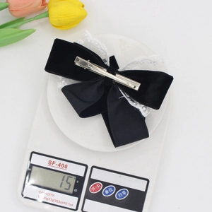 Elegant black velvet and lace bow hair clip weighing 15g with metal spring fastener