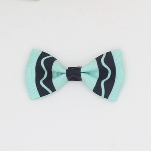 Close-up of mint green grosgrain ribbon bow with black wavy pattern for kids