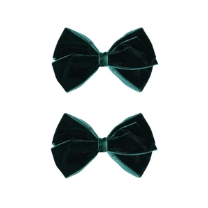 Close-up of dark green velvet bow hair clips with soft texture and elegant sheen