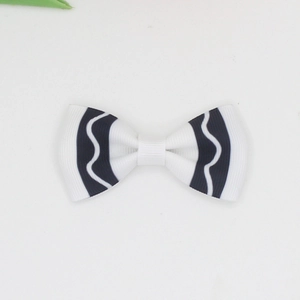 Close-up of white grosgrain ribbon hair bow with black wavy pattern for girls