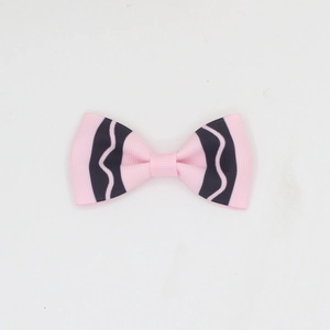 Detailed macro view of pink and navy striped grosgrain ribbon texture on handmade bow clips