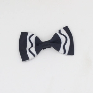 Detailed macro view of black and white wavy striped ribbon bow hair clip for girls