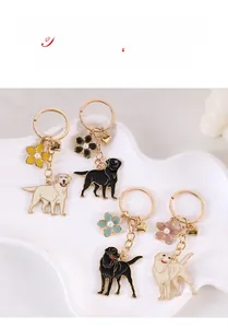 Detailed macro view of Labrador retriever keychains with painted enamel and pearl flowers