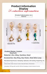Detail of fish and crab charms with heart buckle and pearl in gold-tone finish