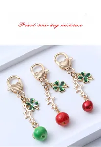 Detail of clover keychain featuring heart spring clasp and gold alloy star chain links