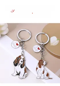 Close-up of metal dog breed keychains with a polished I Heart Dogs charm and silver link chain