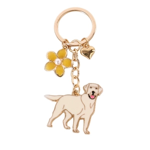 Golden Labrador dog keychain with a yellow flower and heart charm on a white background