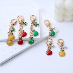 Three-color apple keychains in red, yellow, and green with crystal leaf and pearl charms
