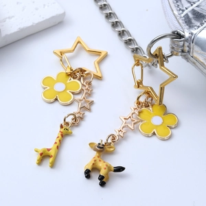 Cute cartoon giraffe keychain with gold star clasp and yellow floral chain accessory