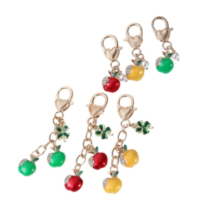 Three-color apple keychain with lobster clasp, pearl, and rhinestone leaf charm detail