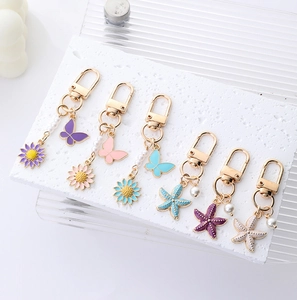 Chic butterfly and daisy metal keychains with faux pearls and gold lobster clasps