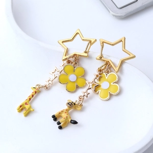 Cute cartoon giraffe earrings with hollow stars and yellow flowers on a white tray