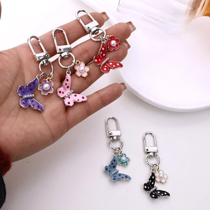 Silver alloy butterfly keychain with enamel dots and pearl flower charm in five colors
