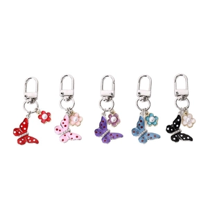 Silver butterfly keychain set with five colorful enamel charms and small flower pendants