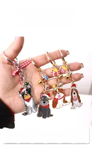 Close-up of festive Christmas dog keychains with Santa hats and jingling small bells