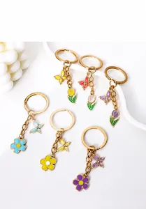 Detailed set of six colorful butterfly and floral enamel metal keychains for bags