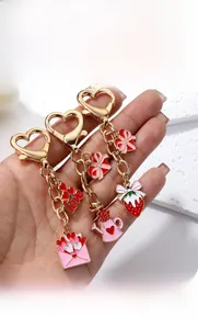 Detail of alloy heart keychain with gold lobster clasp and colorful enamel charms