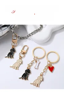 Detail view of golden alloy retriever keychains with red heart and bone charms